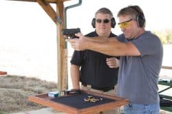 NRA Gun Safety Instructor teaching a student how to hold a handgun