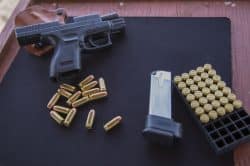 A photo of a handgun with bullet magazines