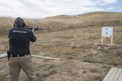 Photo of a man shooting a rifle at the gun range