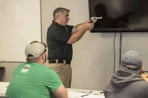 a picture of a Colorado Handgun Safety instructor holding a handgun