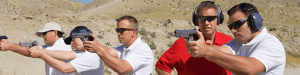 handgun instructor with 4 students holding guns