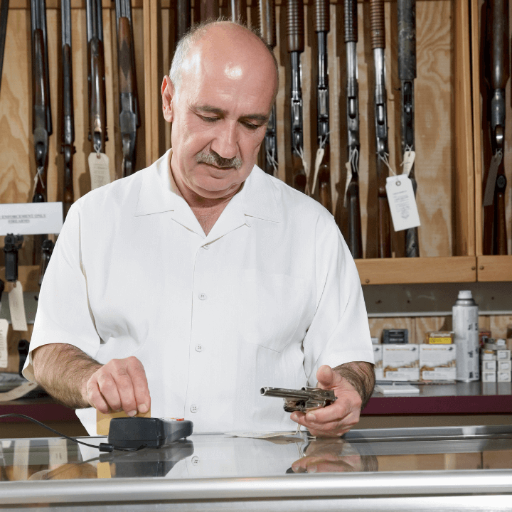 a picture of a man holding a revolver in a gun shop