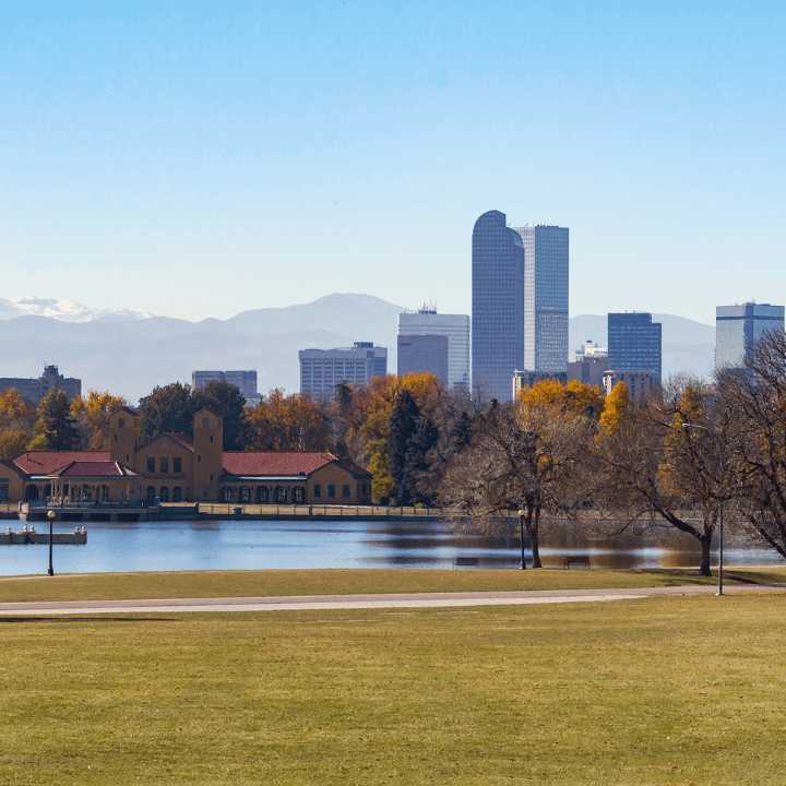 The image shows a park in Denver with the city skyline in the back.