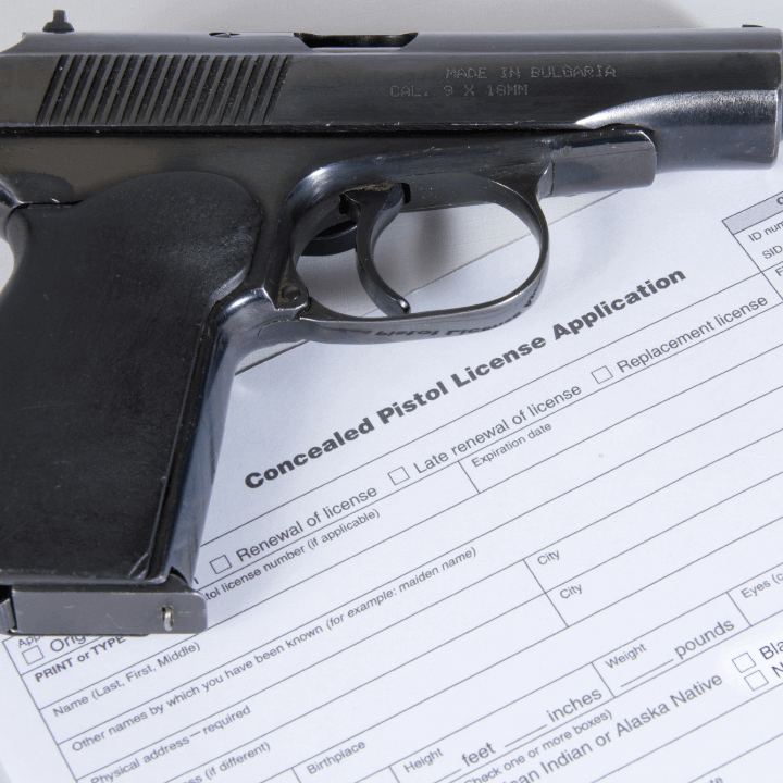 A picture of a handgun and CCW permit.