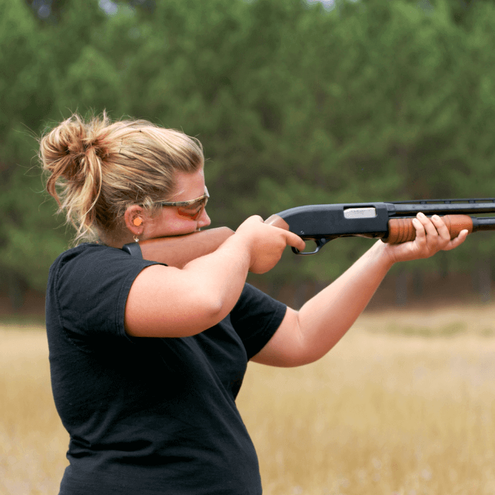A picture of a woman shooting a gun.