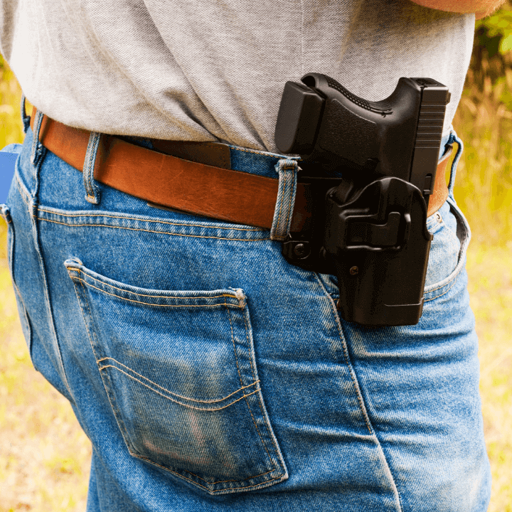 a picture of a firearm in a holster on a man's belt