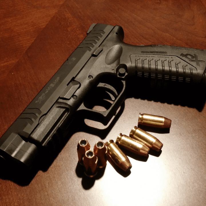 A picture of a handgun and ammo.