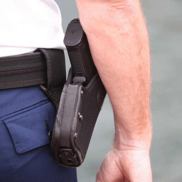 A picture of a handgun inside of a waist holster.