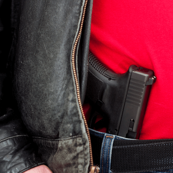 A picture of a handgun in a waistband.