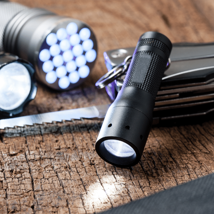 A pile of flashlights on a table