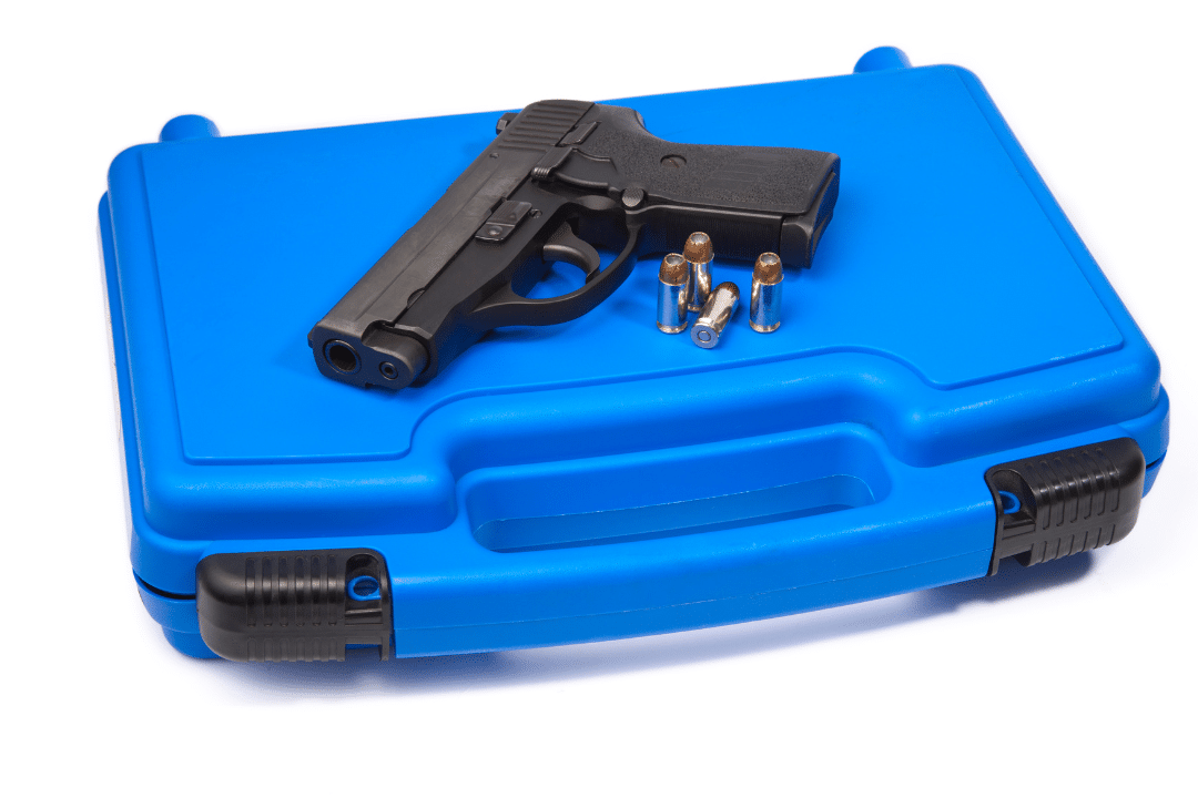 A handgun is on top of a safe storage box.