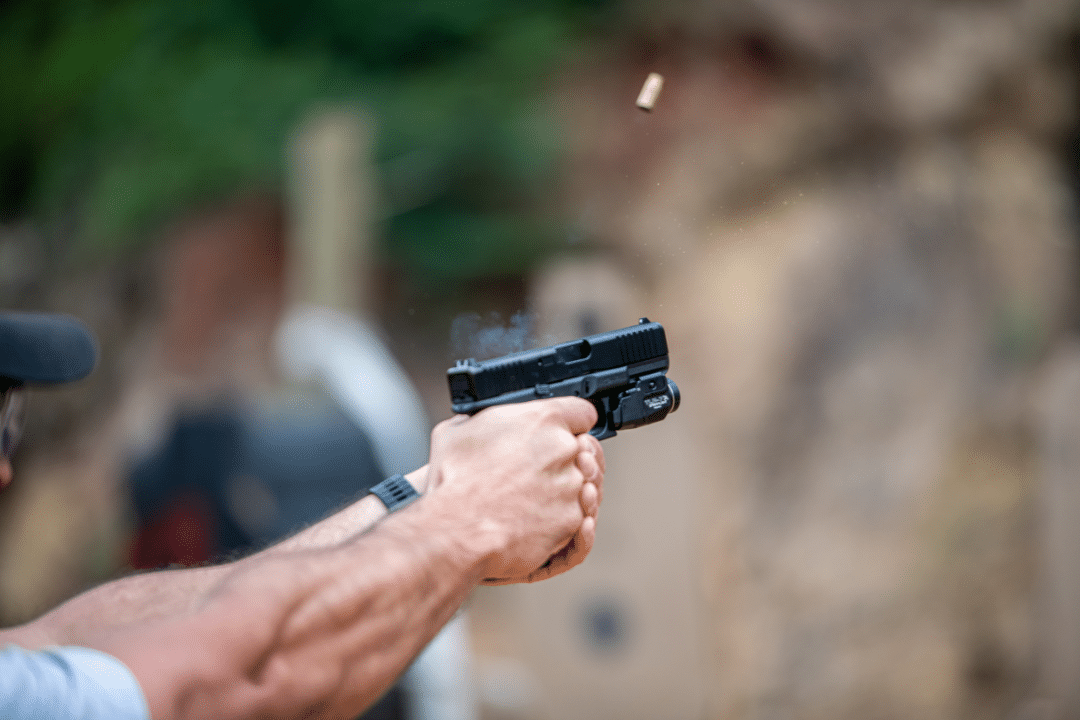 Practicing shooting handgun at firing range.