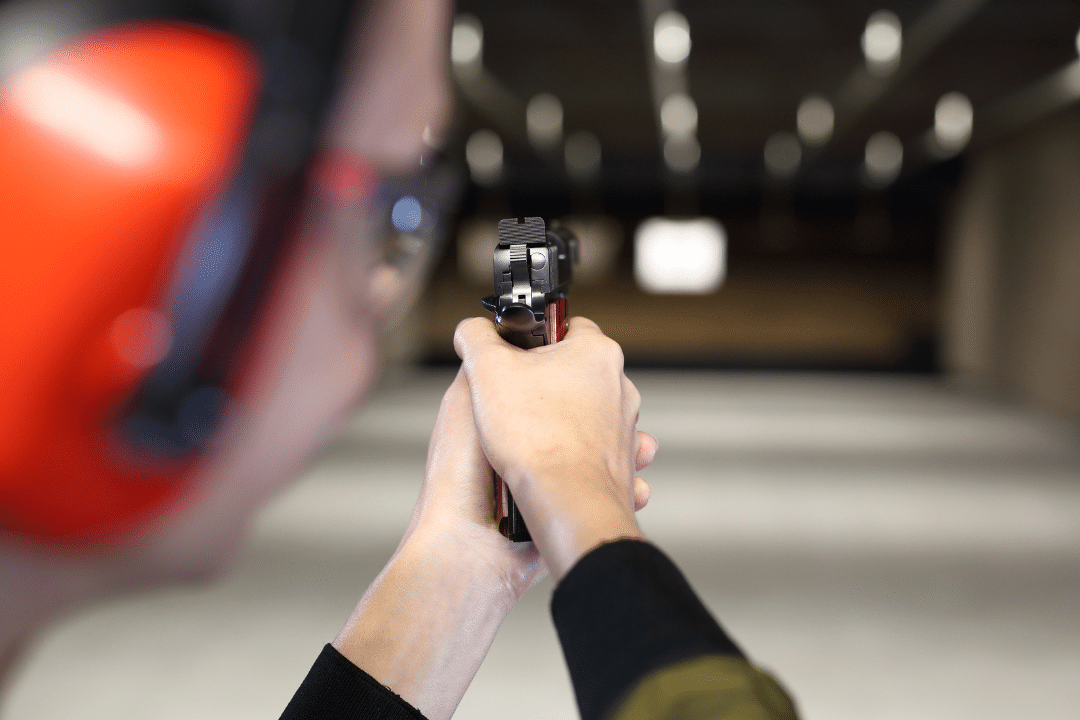 Safely firing a handgun at the shooting range target.