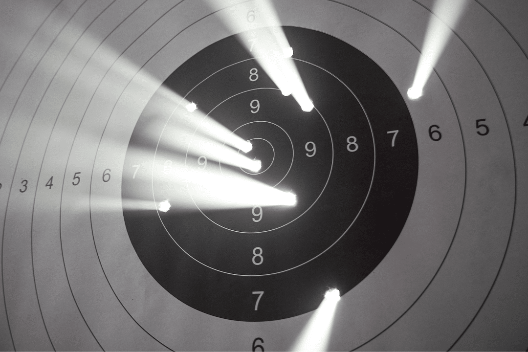 A paper target with bullet holes.