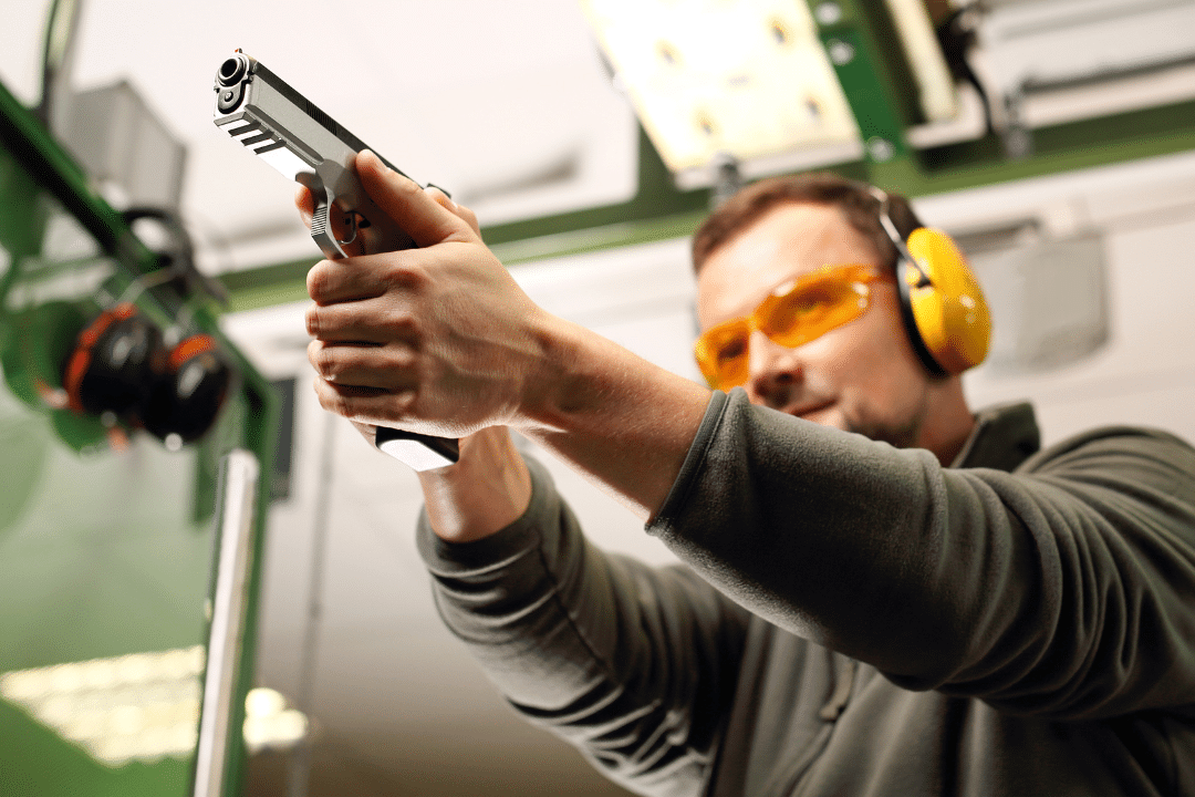 A man is practicing shooting at the firing range.